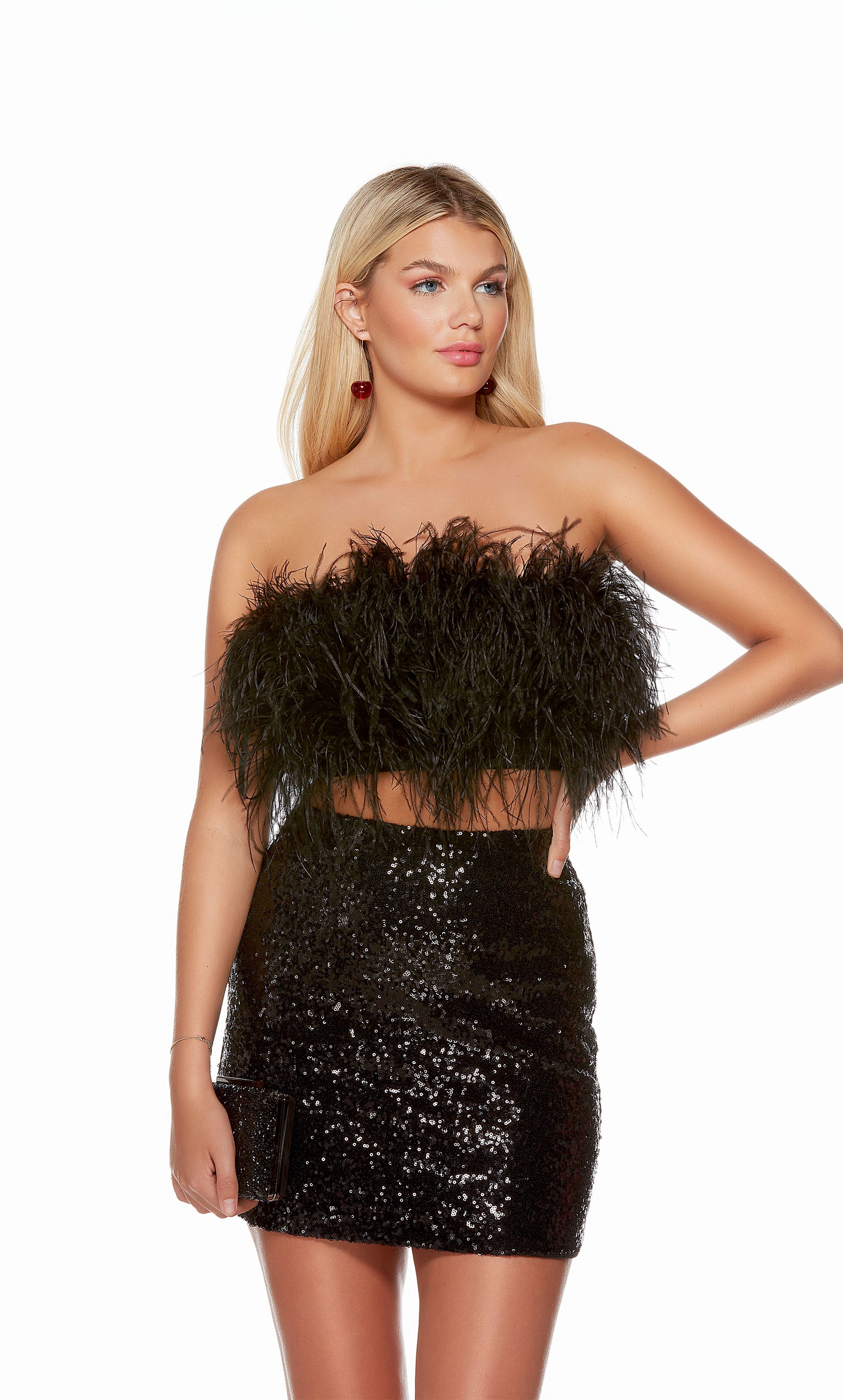 A trendy two-piece homecoming dress consisting of a cropped, strapless feather top, paired with a fitted sequin skirt in classic black.