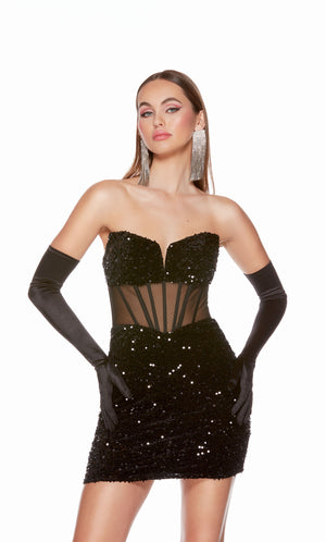 A glamorous corset top dress featuring a strapless sweetheart neckline and sheer bodice, in black plush sequins. The dress was accessorized with long black satin gloves which are not included with dress purchase.