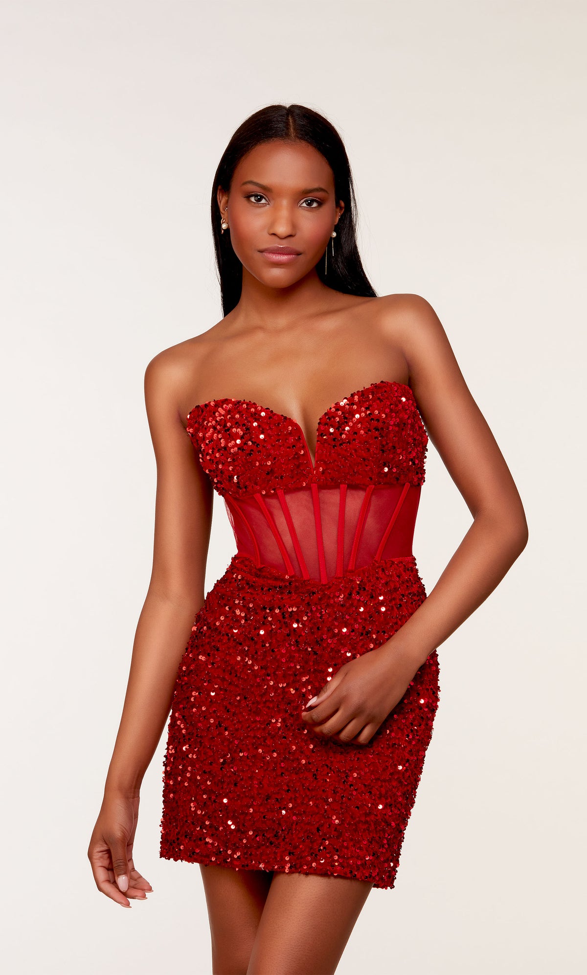 A glamorous corset top dress featuring a strapless sweetheart neckline and sheer bodice, in red plush sequins.