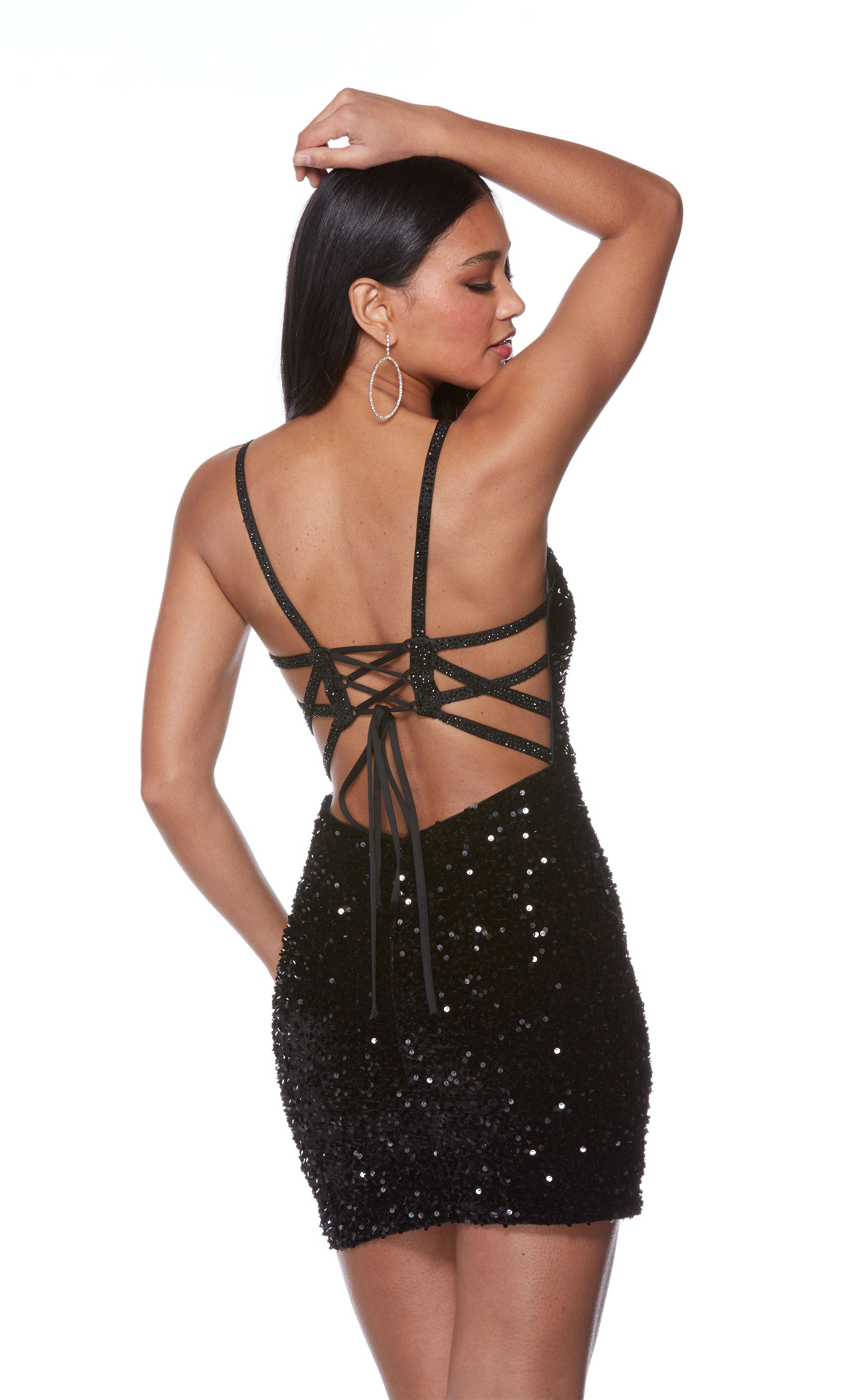 A black, sparkly sequin short formal dress with a straight across neckline and a strappy open back.