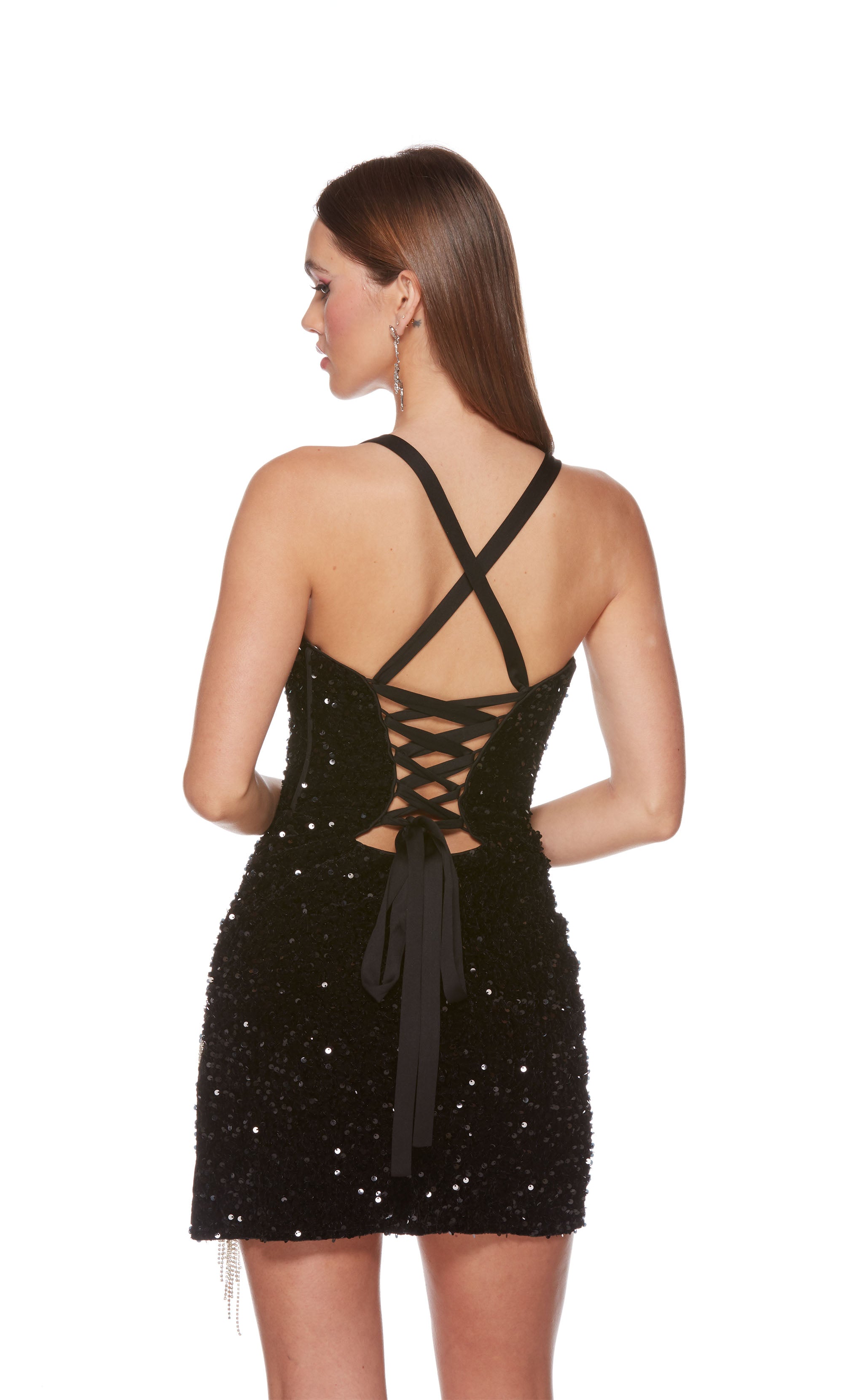 A playful, plunging neckline black sequin corset dress highlighting a side slit adorned with sparkly silver fringe and a lace-up back, for the perfect fit. The dress was accessorized with long black satin gloves which are not included with dress purchase.