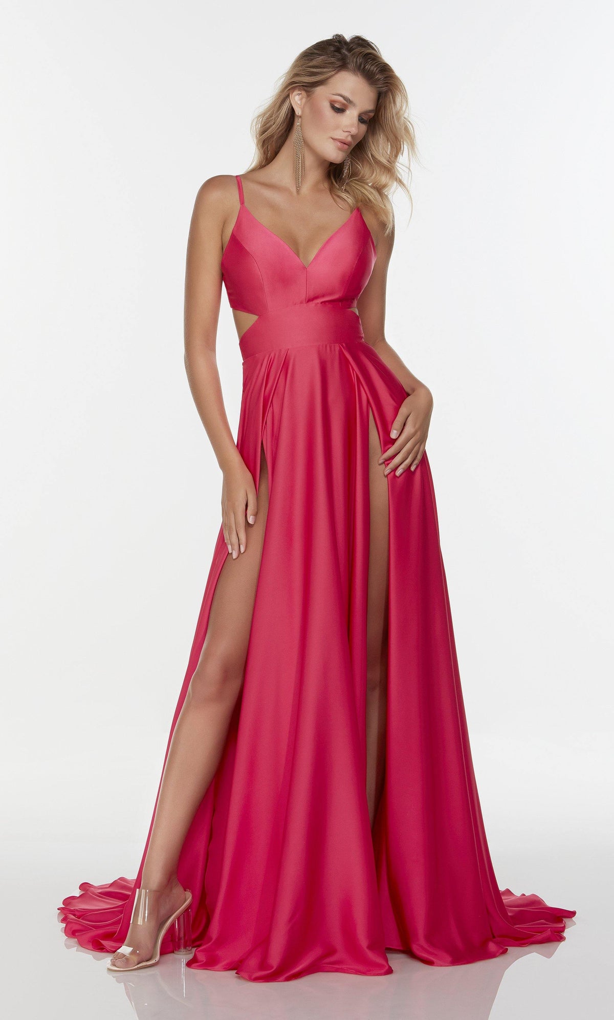 Long hot pink prom dress with a v neckline, side cut outs, and dual slits.
