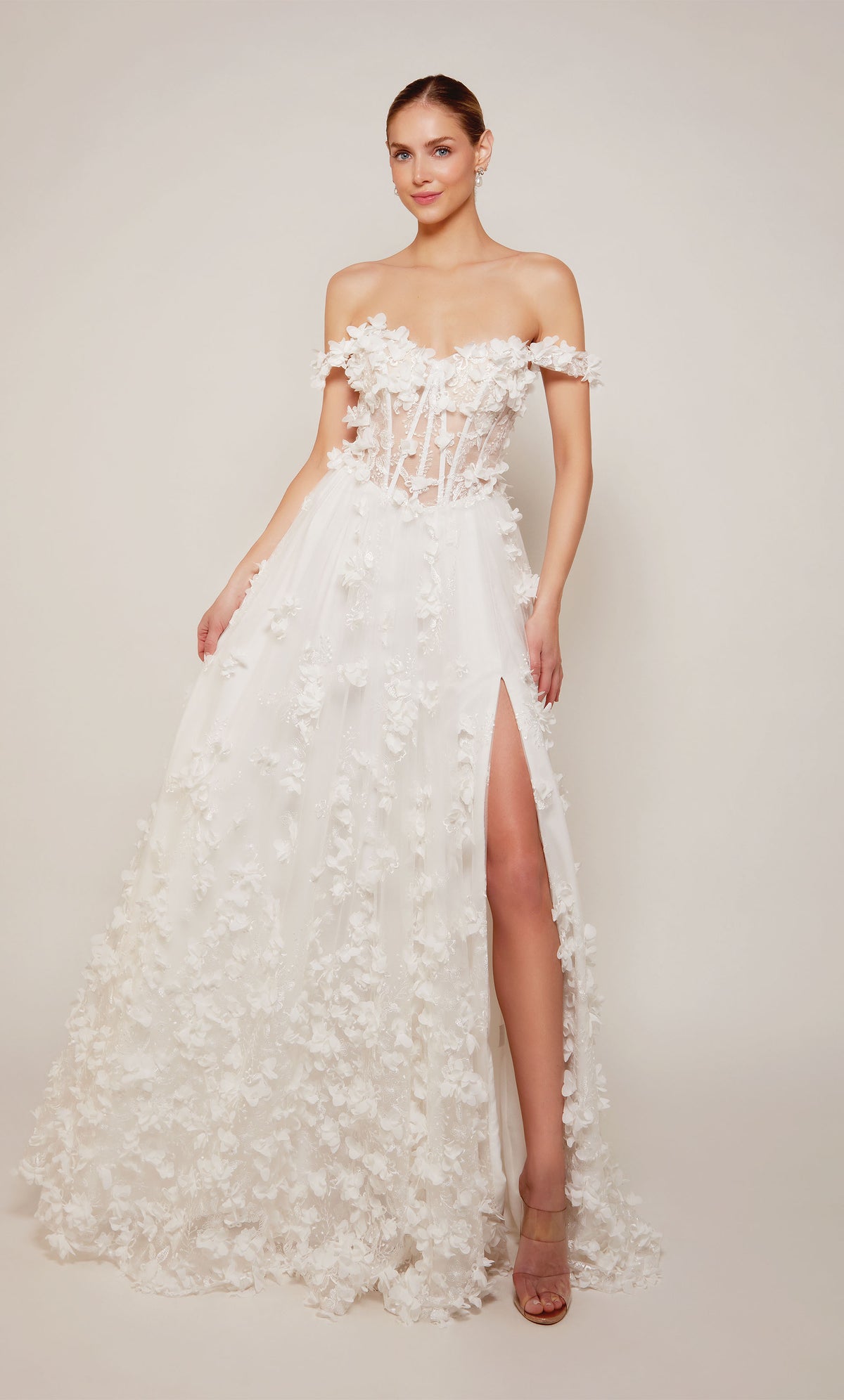 Ivory off the shoulder corset dress with an sheer lace up bodice and delicate 3d flowers throughout.