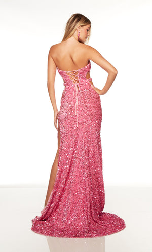 Long pink prom dress with a lace up back, fringed side slit, and train.