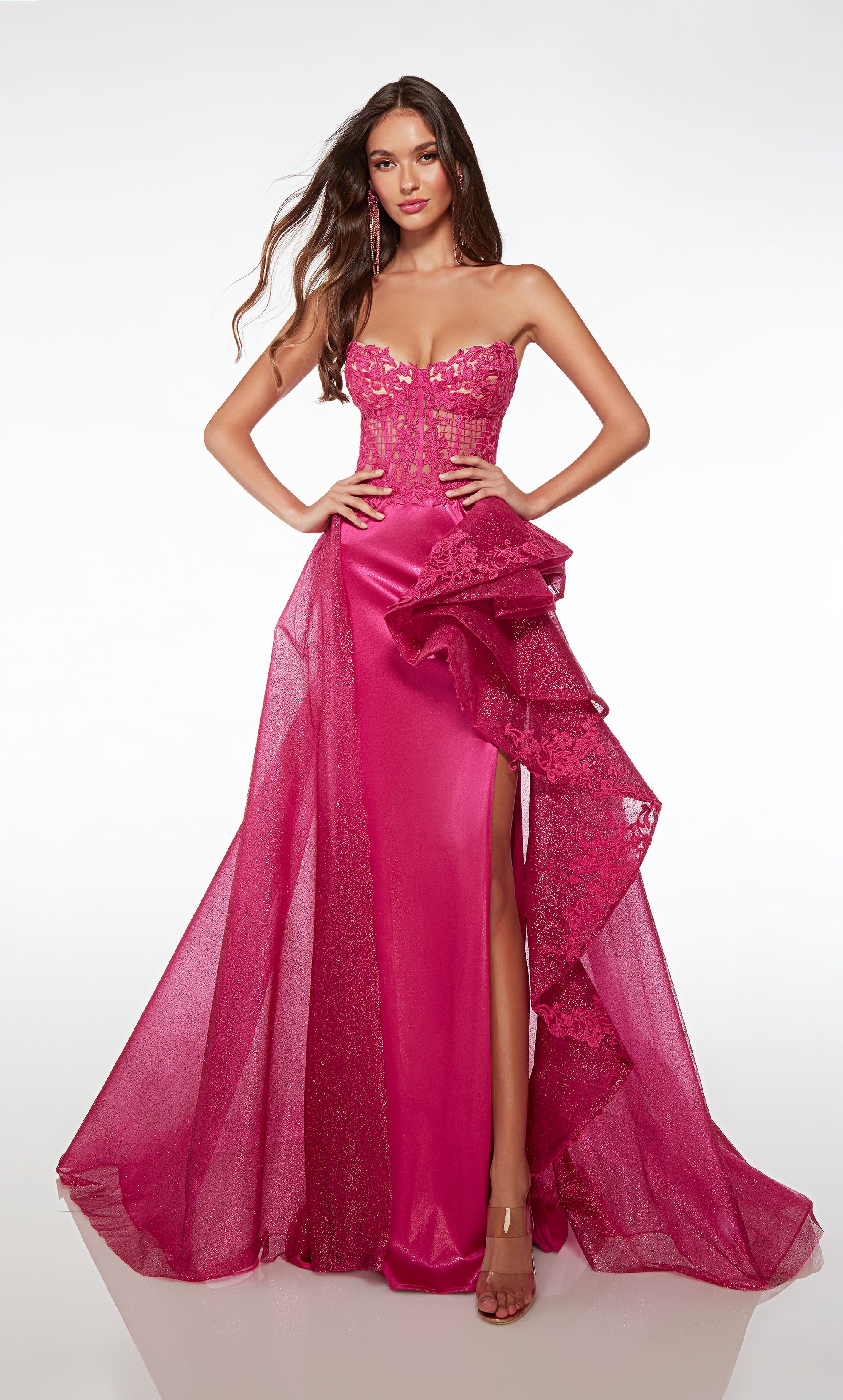 Chic strapless pink pageant dress featuring an lace corset top, high side slit, and an dramatic ruffled detachable skirt for added flair.