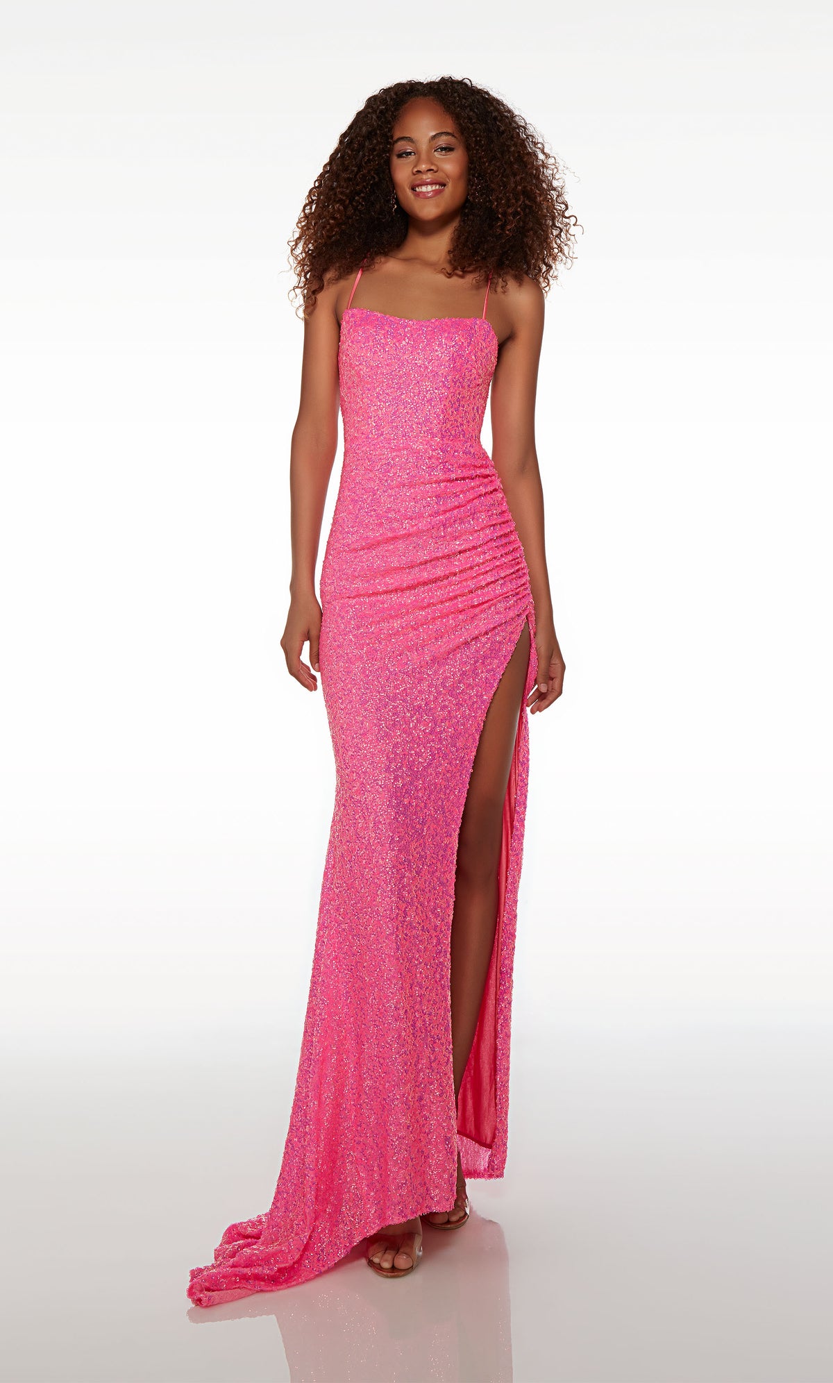 Square-neck pink prom dress with ruching detail, side slit, strappy open back, and an stylish train in pink sequins.