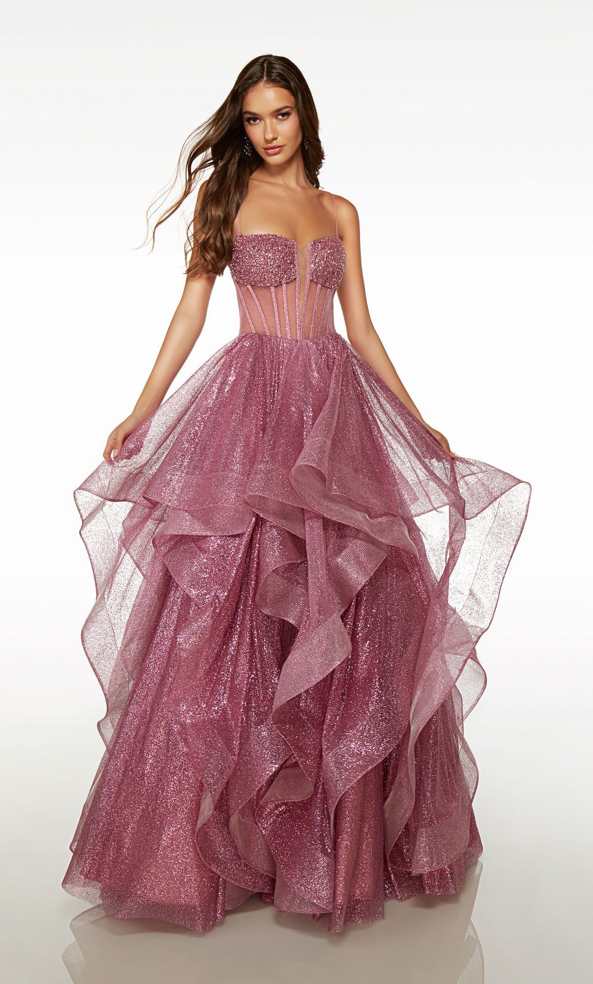 Elegant pink corset ball gown with an hand-beaded sheer bodice and an ruffled skirt in glitter tulle fabric for an glamorous and enchanting look.