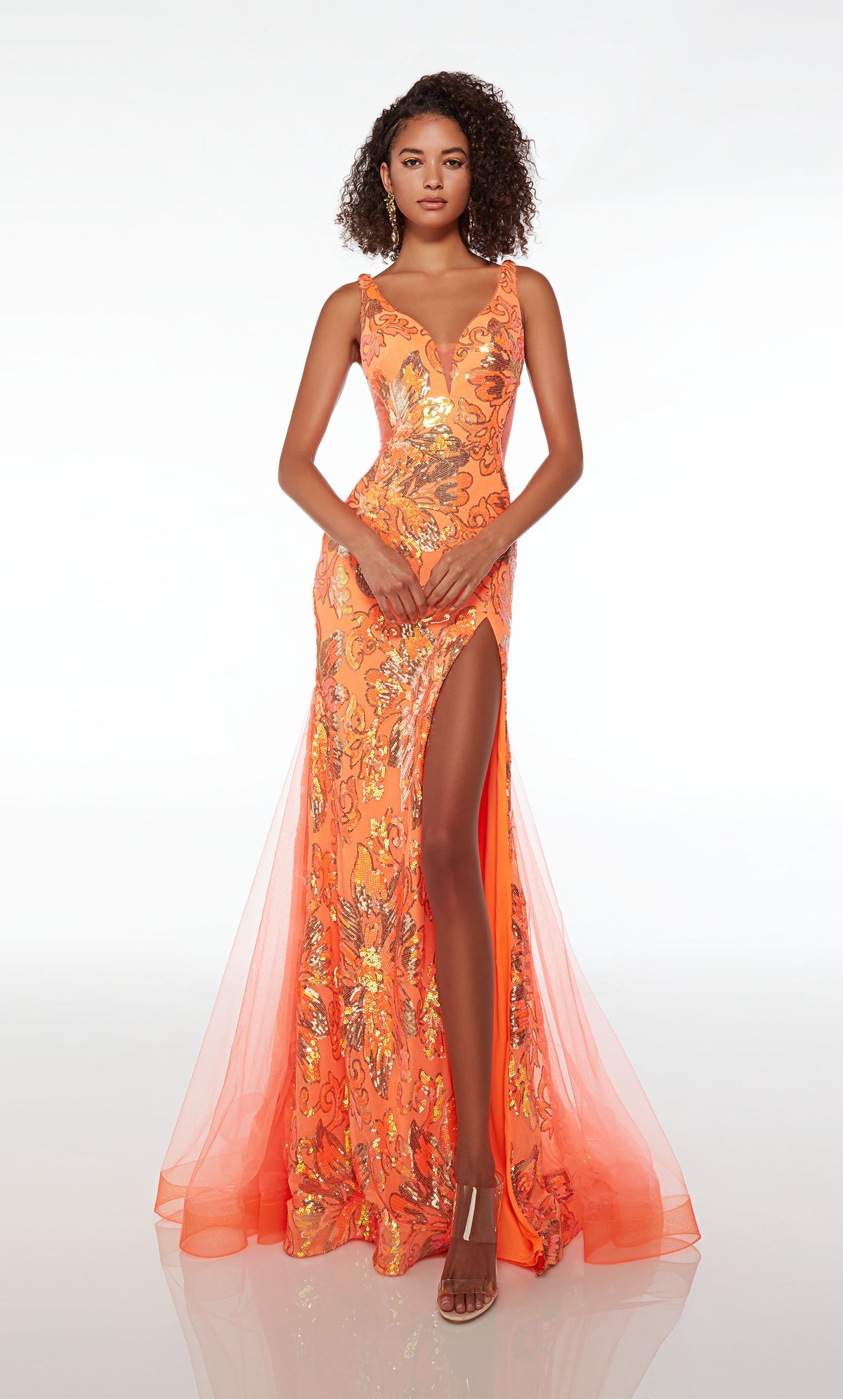 Alluring plunging mermaid dress in orange tulle with high slit, illusion side cutouts, V-shaped back, and an train, adorned with an sequin floral design.