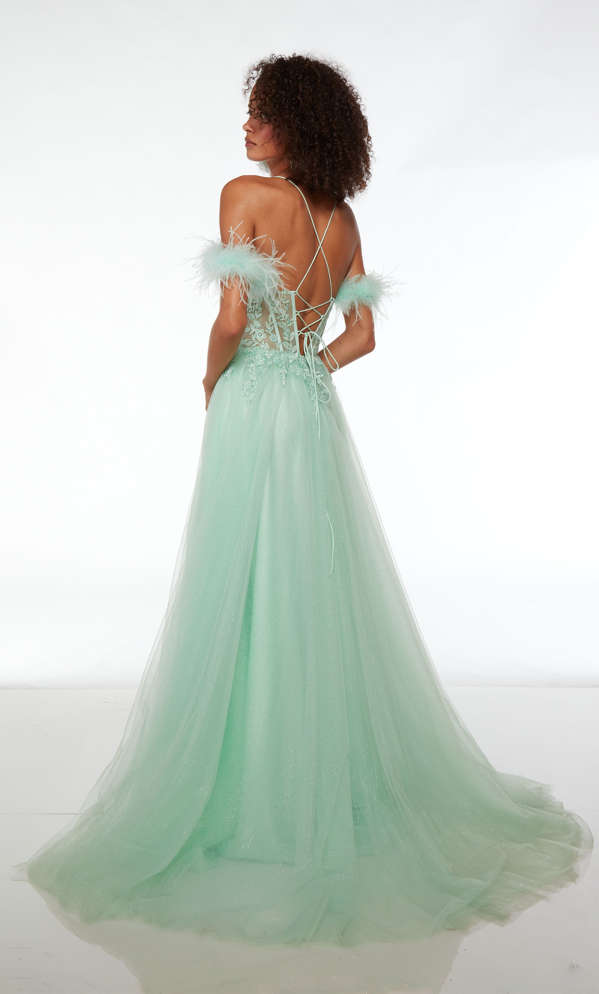 Green prom dress: sheer lace corset, high slit, detachable feather straps, A-line glitter skirt, crisscross lace-up back, and an train for an stylish look.