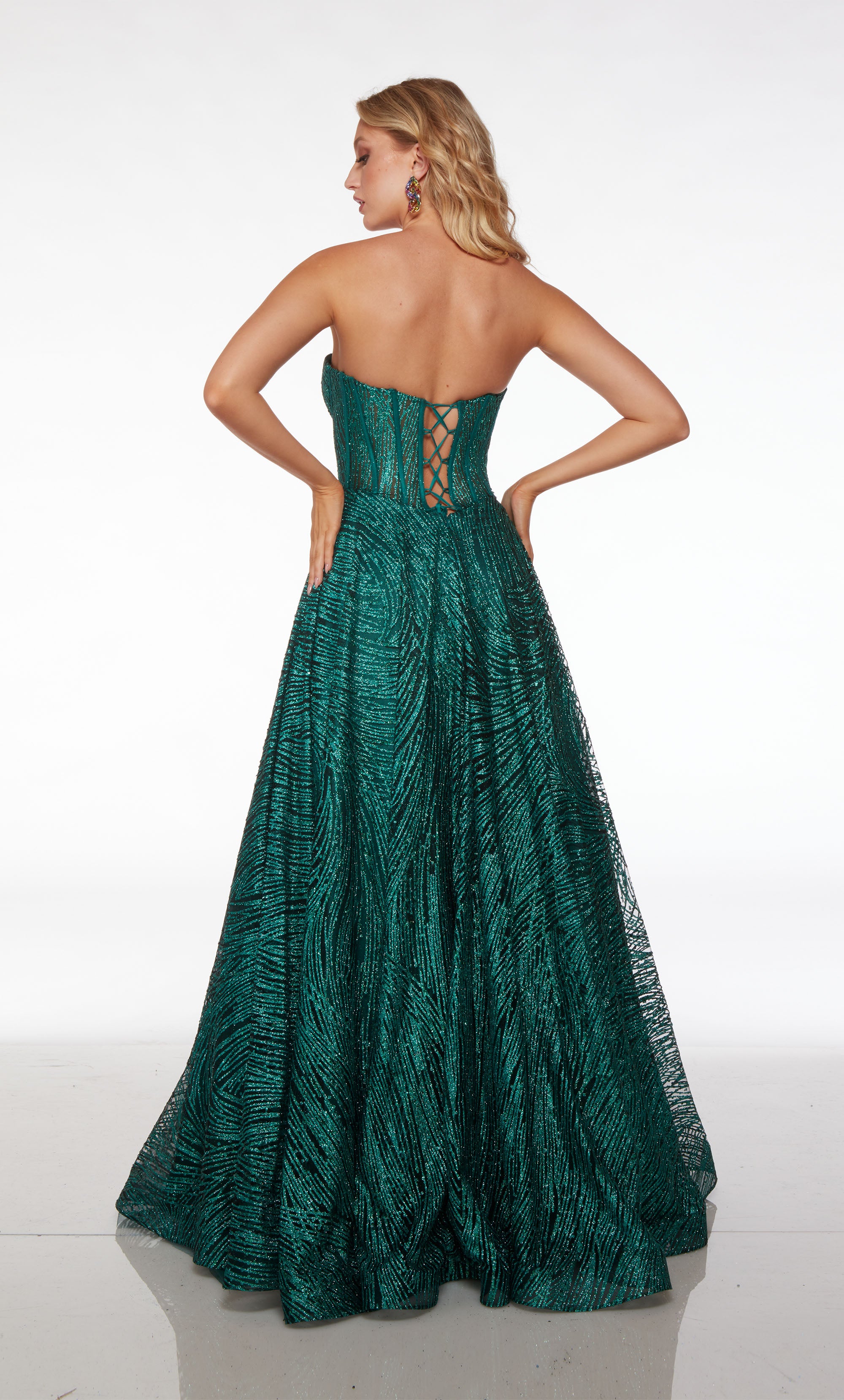 Strapless green corset dress with A-line skirt, lace-up back, and pockets, in stunning glitter tulle fabric for an chic and functional look.