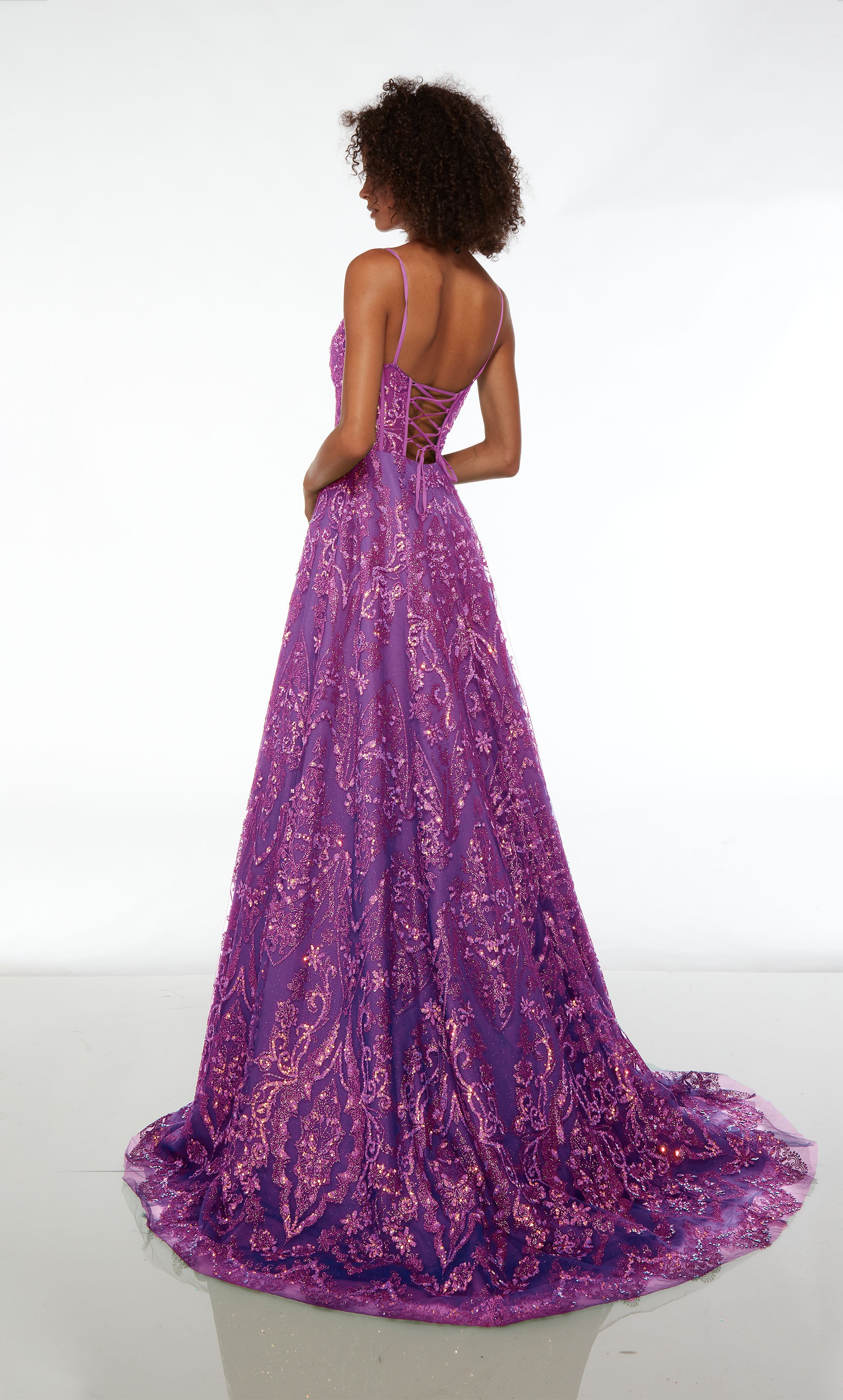 Purple prom dress: plunging neckline, corset top, spaghetti straps, A-line skirt, lace-up back, train, glitter embellishments—unique and captivating.