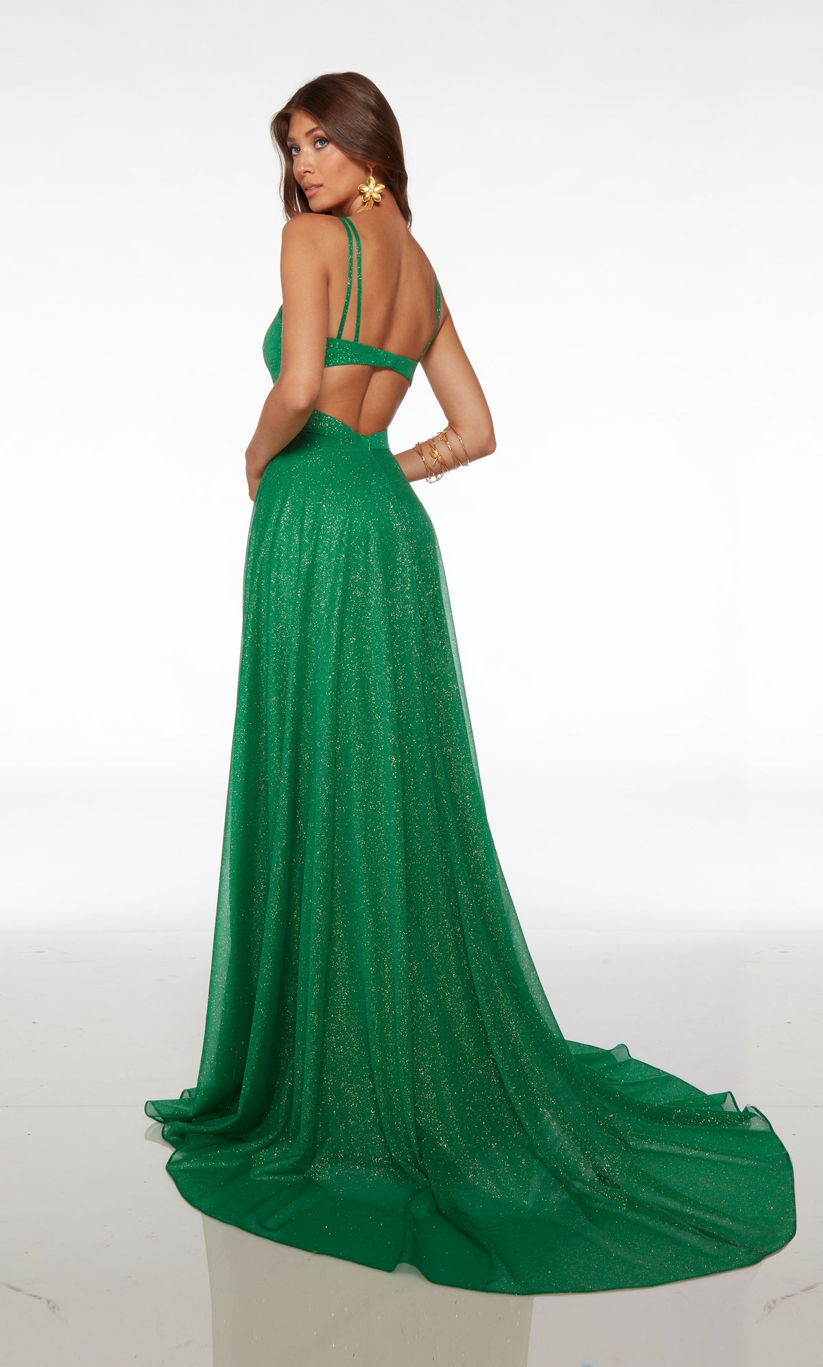 Flowy glitter tulle A-line formal dress with an V neckline, dual spaghetti straps, side cutouts, slit, open back, and elegant train in emerald green.