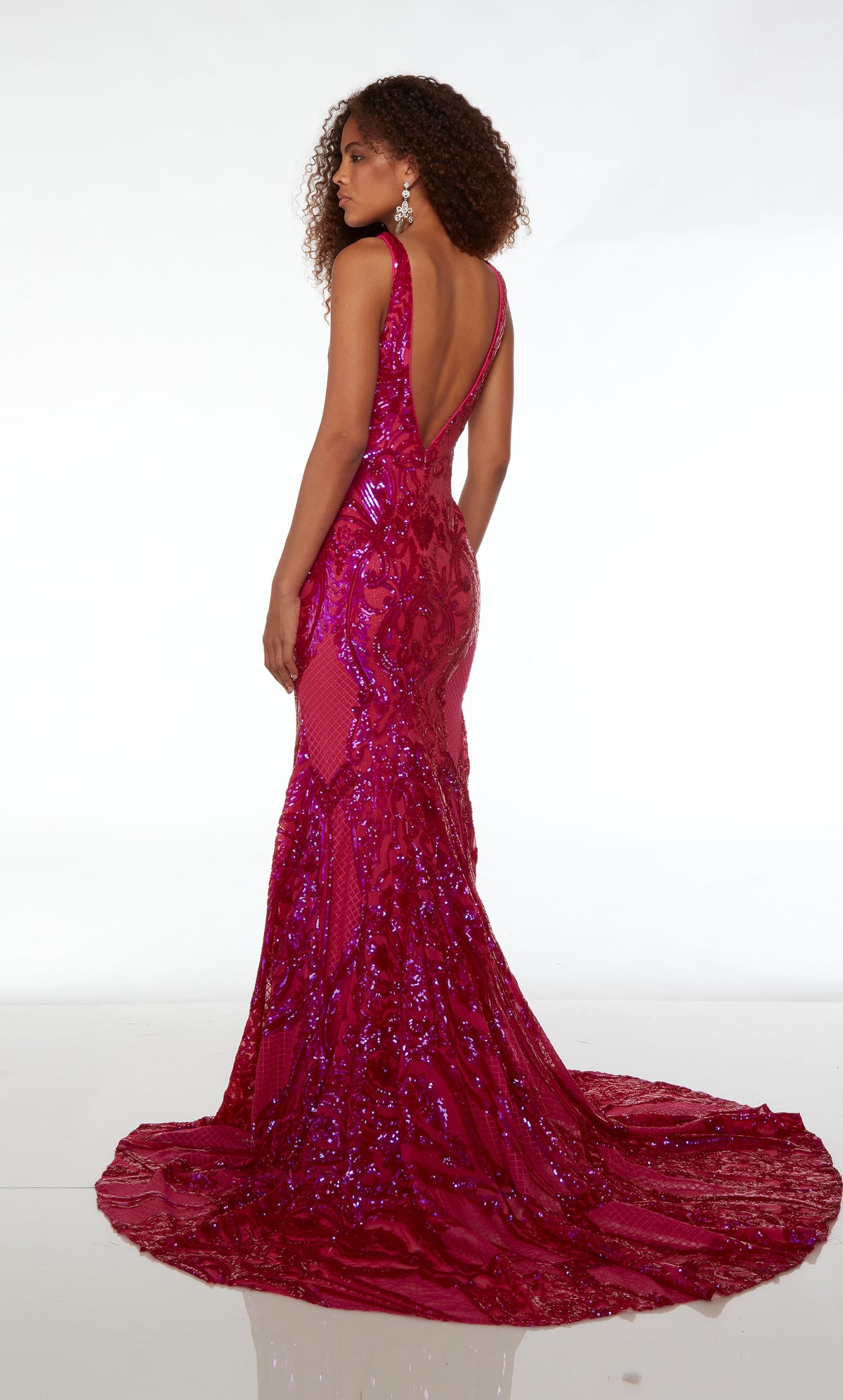 Raspberry pink formal dress: plunging neckline, illusion cutouts, paisley-patterned iridescent sequins, V-shaped back, and graceful train.