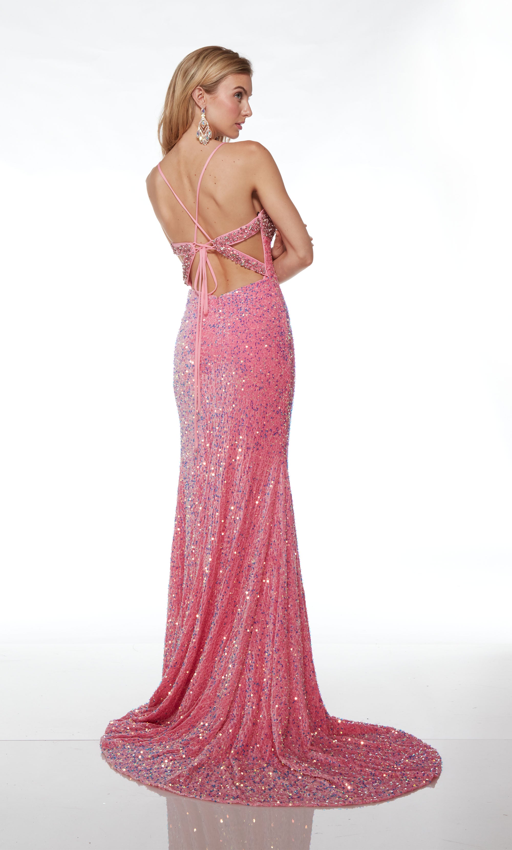 Fitted iridescent pink sequin dress with sweetheart neckline, rhinestone embellished bust, high slit, crisscross lace-up back, and an stunning train.