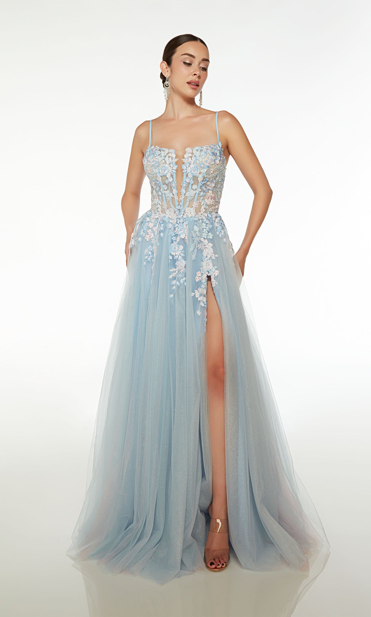Light blue-pink A-line tulle gown with an sheer corset bodice, high slit, spaghetti straps, lace-up back, slight train, and delicate floral lace appliques.