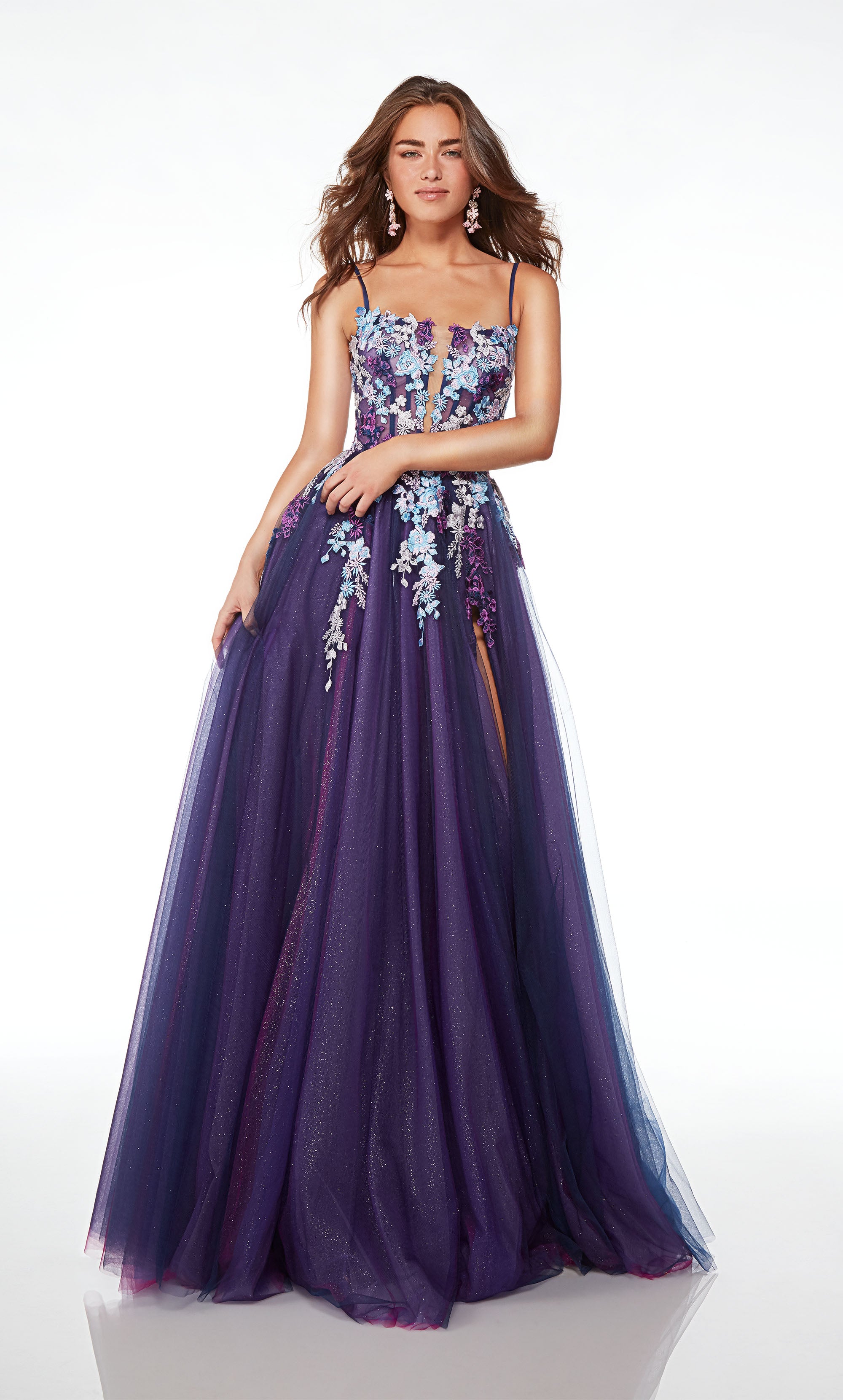 Purple-multi A-line tulle gown with an sheer corset bodice, high slit, spaghetti straps, lace-up back, slight train, and delicate floral lace appliques.