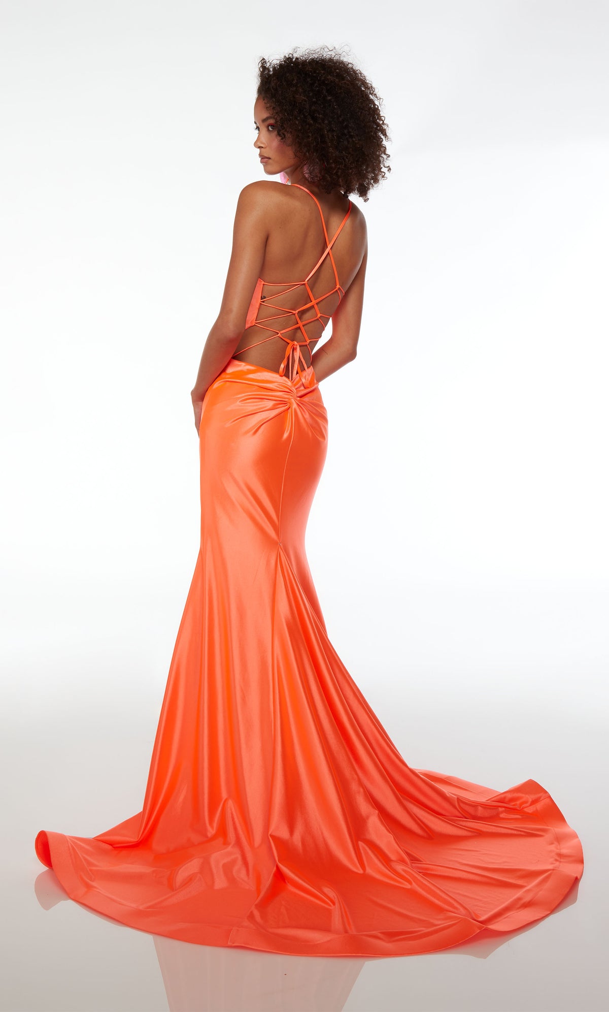 Form fitting orange formal dress in an mermaid silhouette, V neckline, side cutouts, lace-up back, ruching detail, and an long glamorous train.