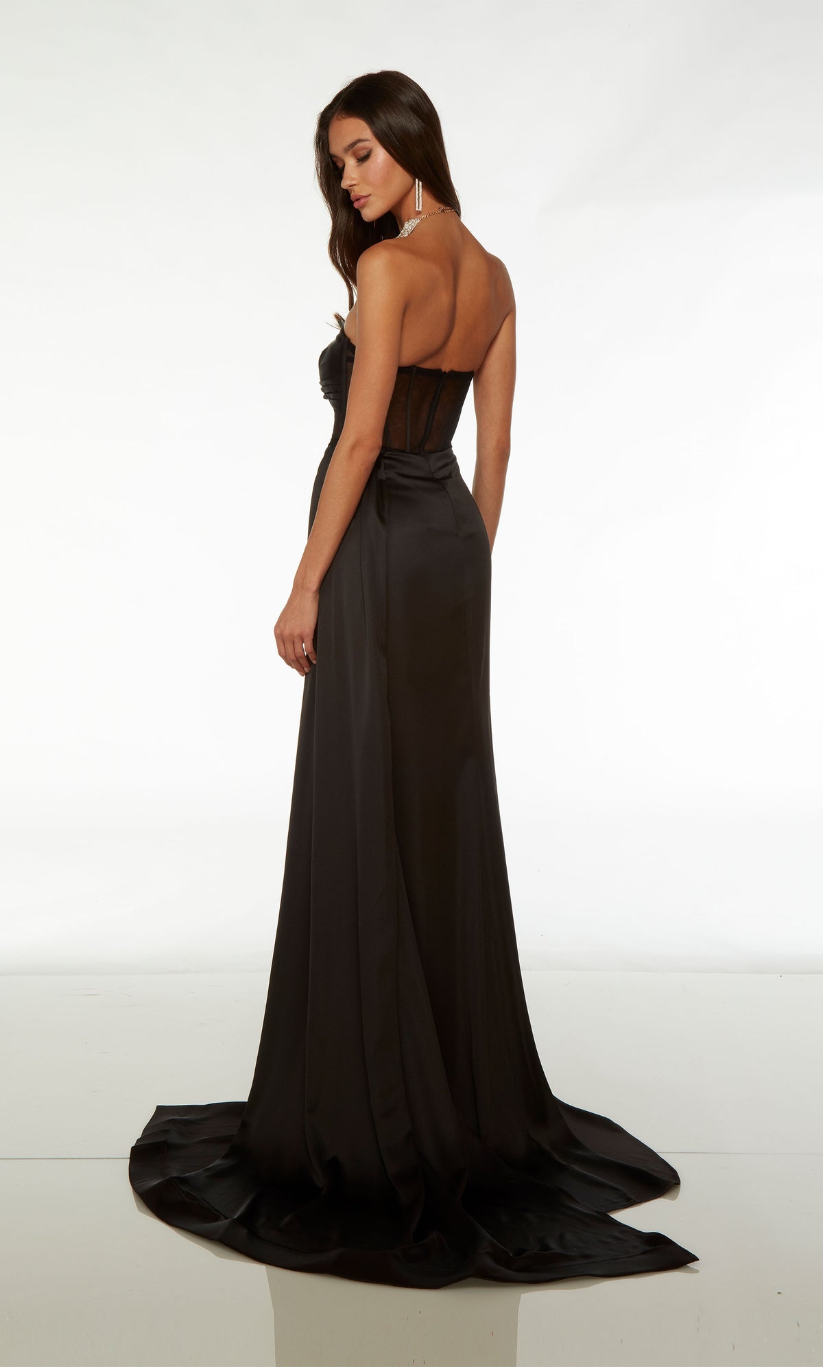 Edgy black evening gown with strapless neckline, sheer corset bodice, high side slit, train, and an detachable side train for added dramatic effect.
