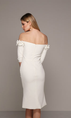 Ivory cocktail midi dress with an off the shoulder bodice enhanced with an airy flower volant.