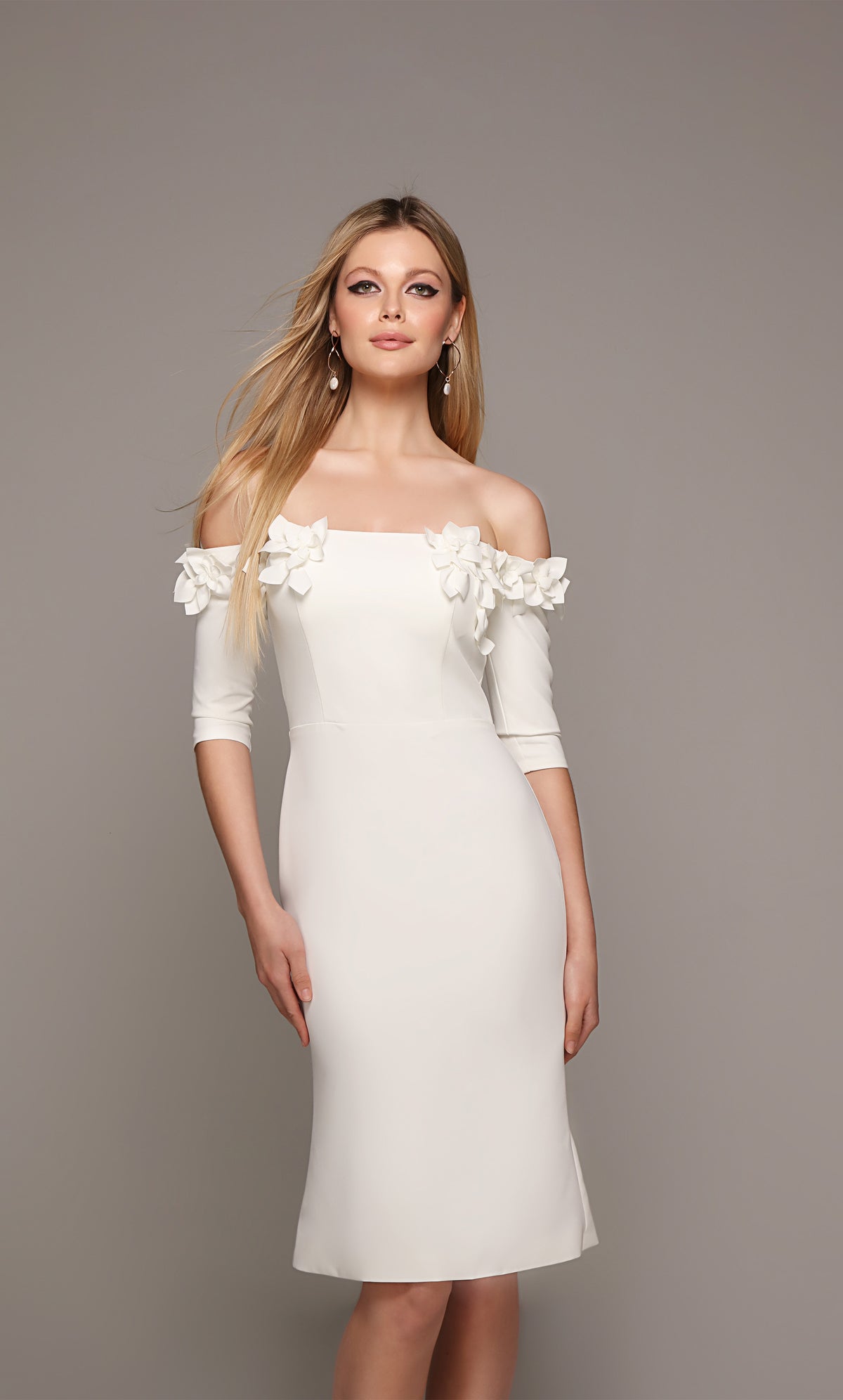 Ivory engagement dress with an off the shoulder bodice enhanced with an airy flower volant.