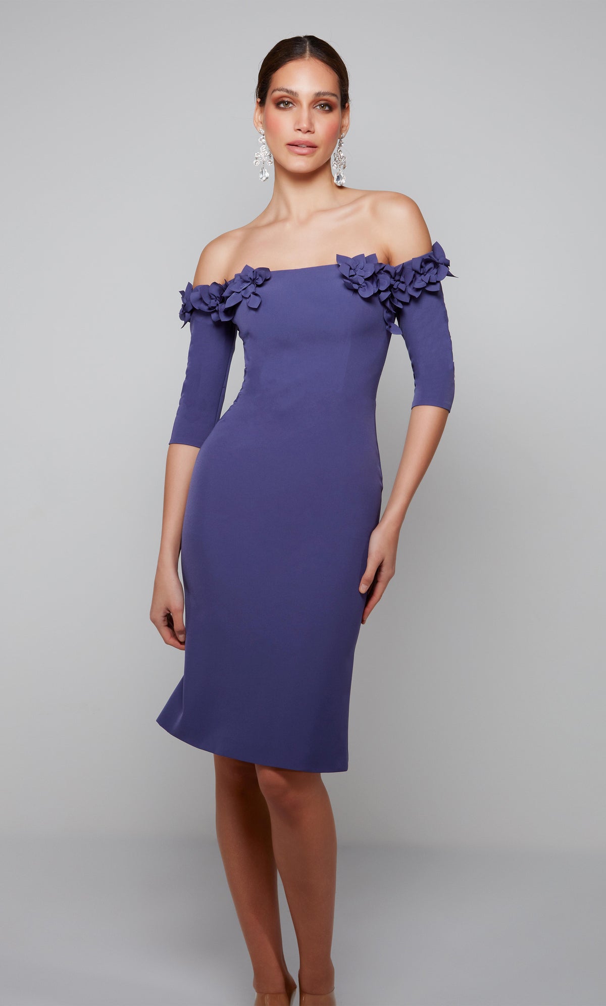 Purple engagement dress with an off the shoulder bodice enhanced with an airy flower volant.