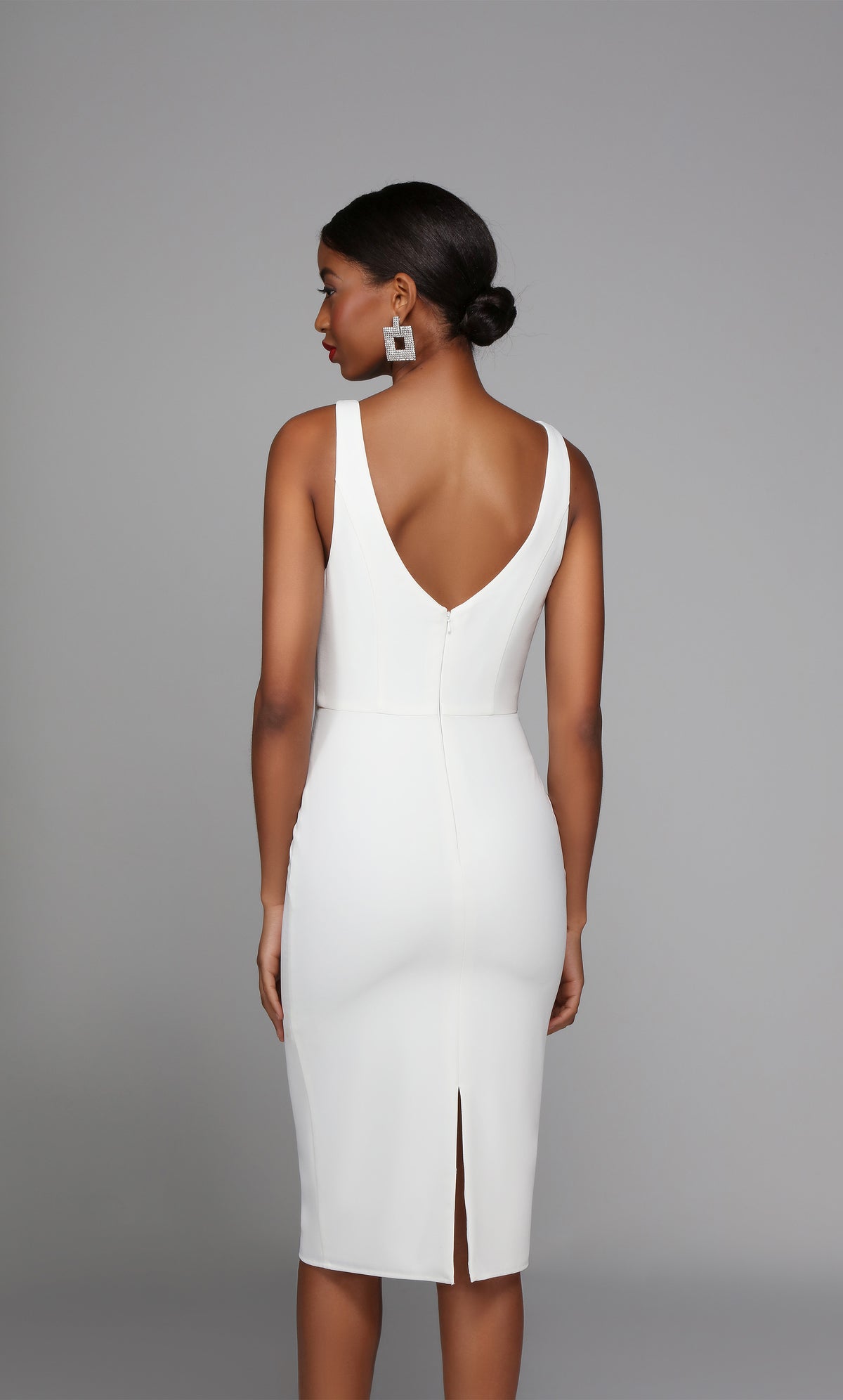 Sleeveless white engagement dress with an elegant V shaped back and a back slit.