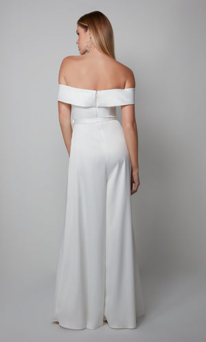 White engagement jumpsuit with an elegant off the shoulder neckline and matching belt at the natural waist.