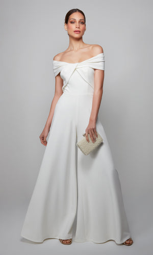 Ivory wedding reception jumpsuit with an off the shoulder neckline.