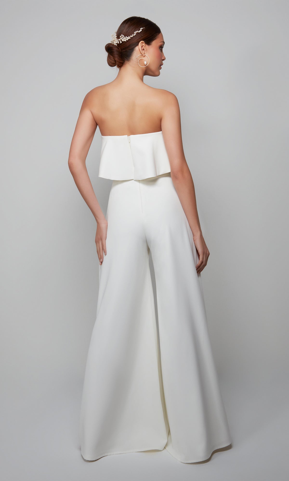 Chic wedding jumpsuit with a ruffle top and zip up back in ivory.