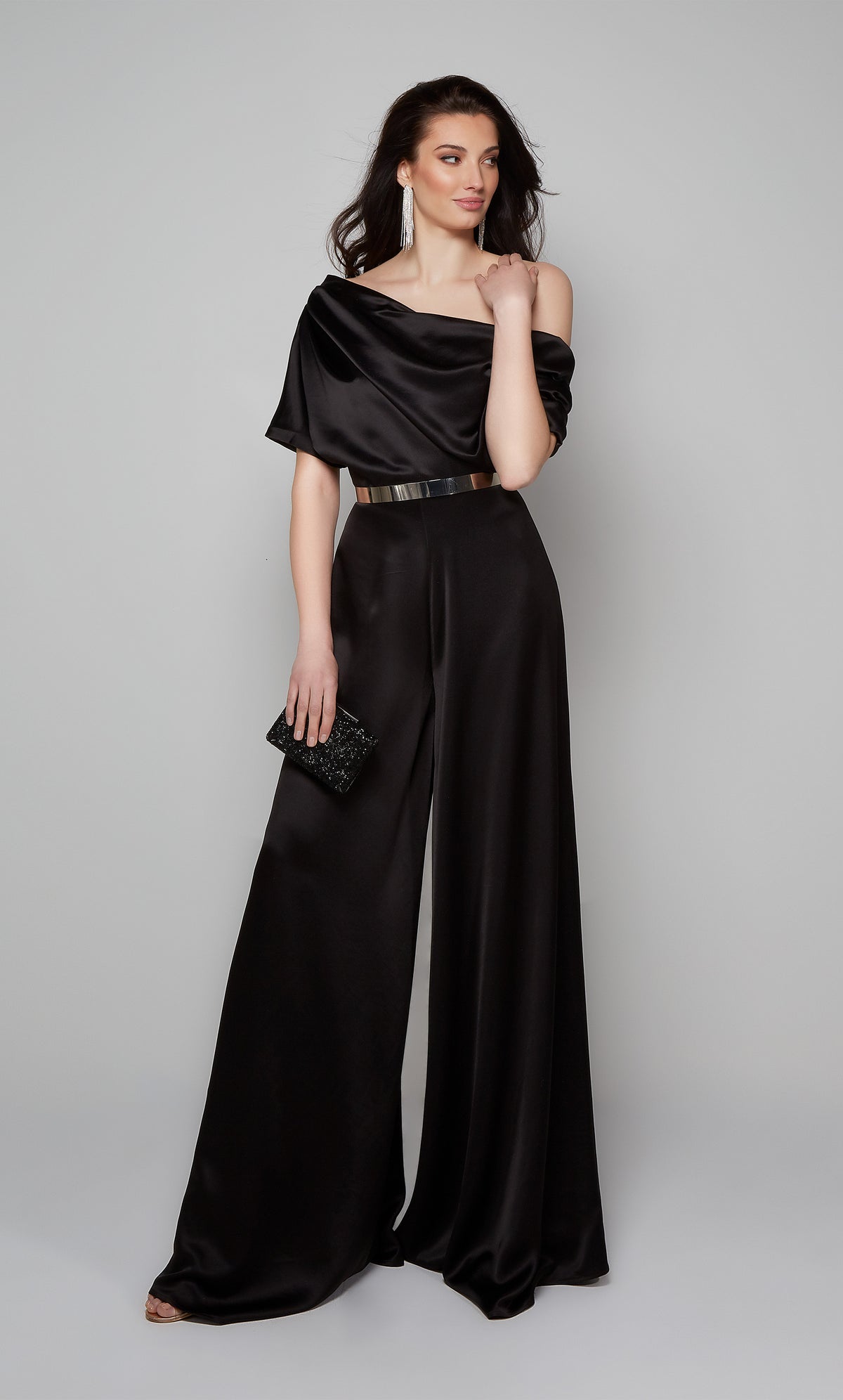 Elegant black jumpsuit with draped one shoulder bodice shown with silver belt. Belt not included with purchase.