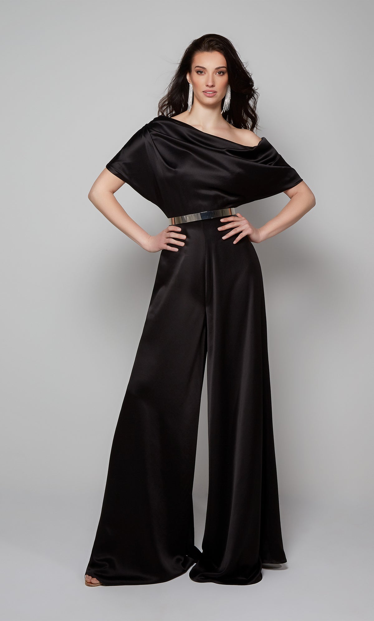 Elegant black jumpsuit with draped one shoulder bodice shown with silver belt. Belt not included with purchase.