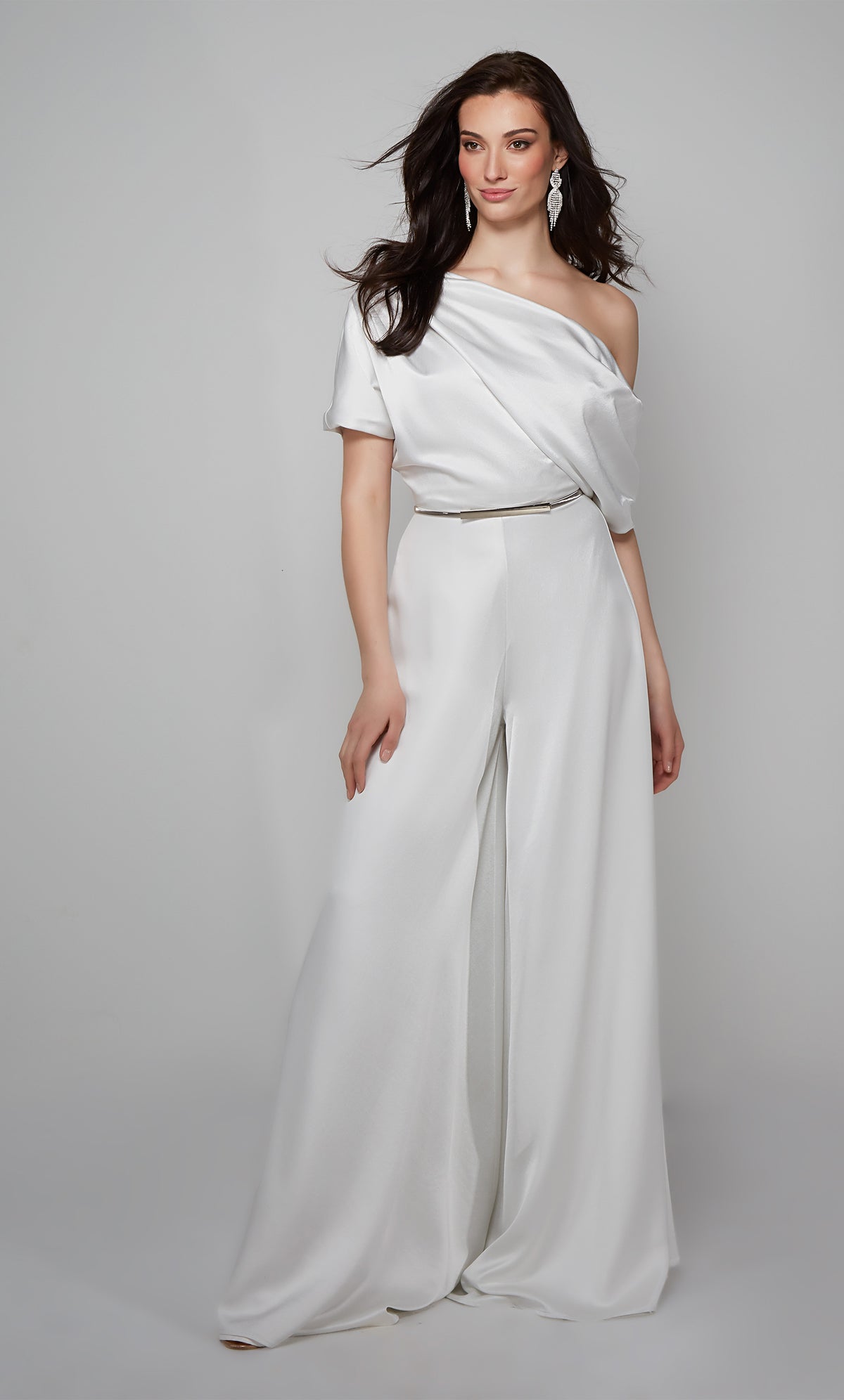 Ivory engagement jumpsuit with a draped one shoulder bodice shown with silver belt. Belt not included with purchase.