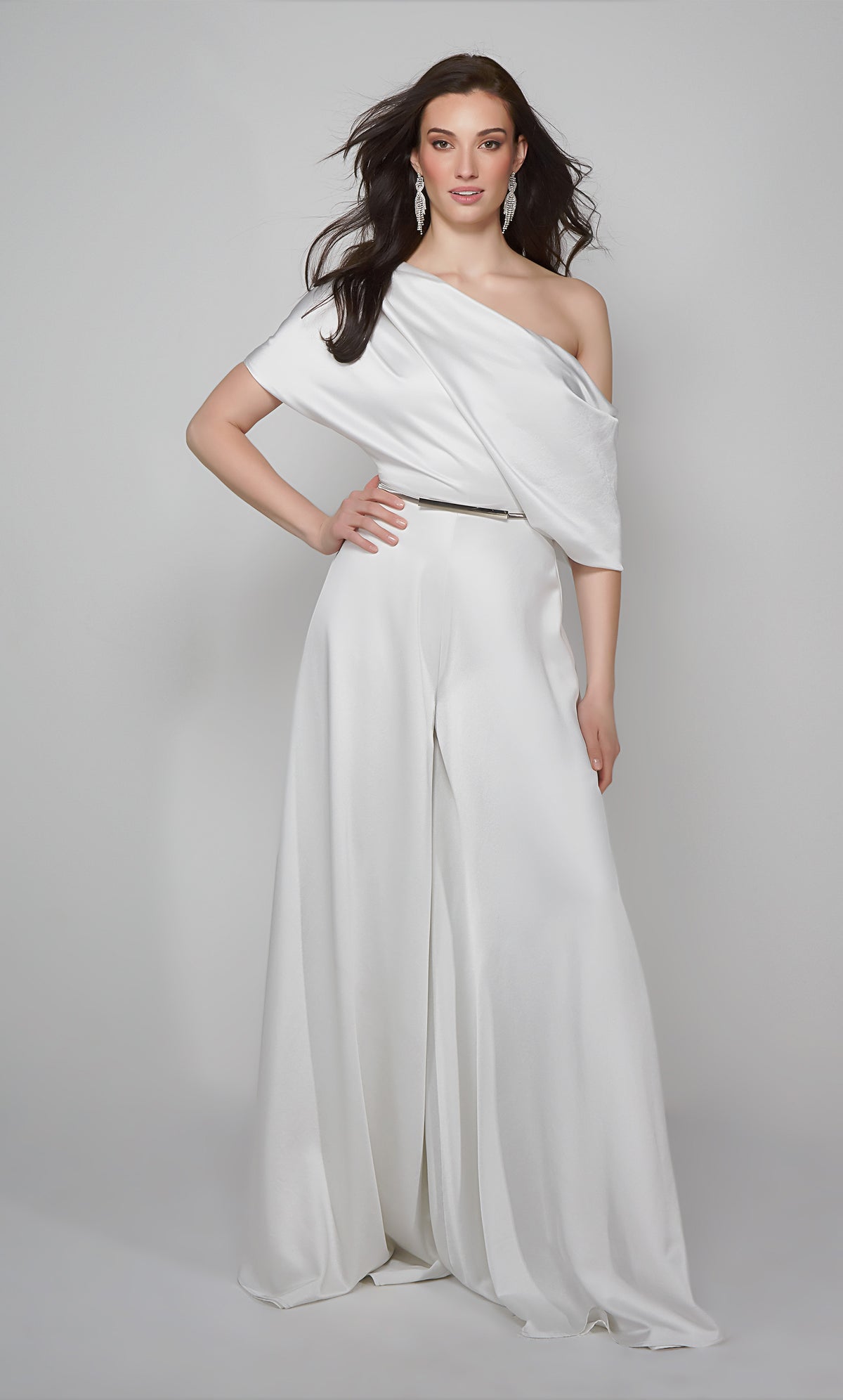 One shoulder jumpsuit with draped bodice in ivory shown with silver belt. Belt not included with purchase.