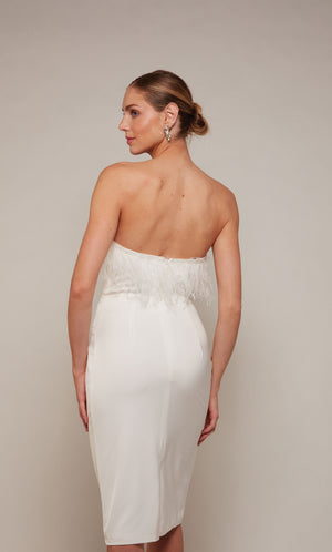 Feather trim strapless midi dress with a closed back and back slit in ivory. Ostrich feathers.