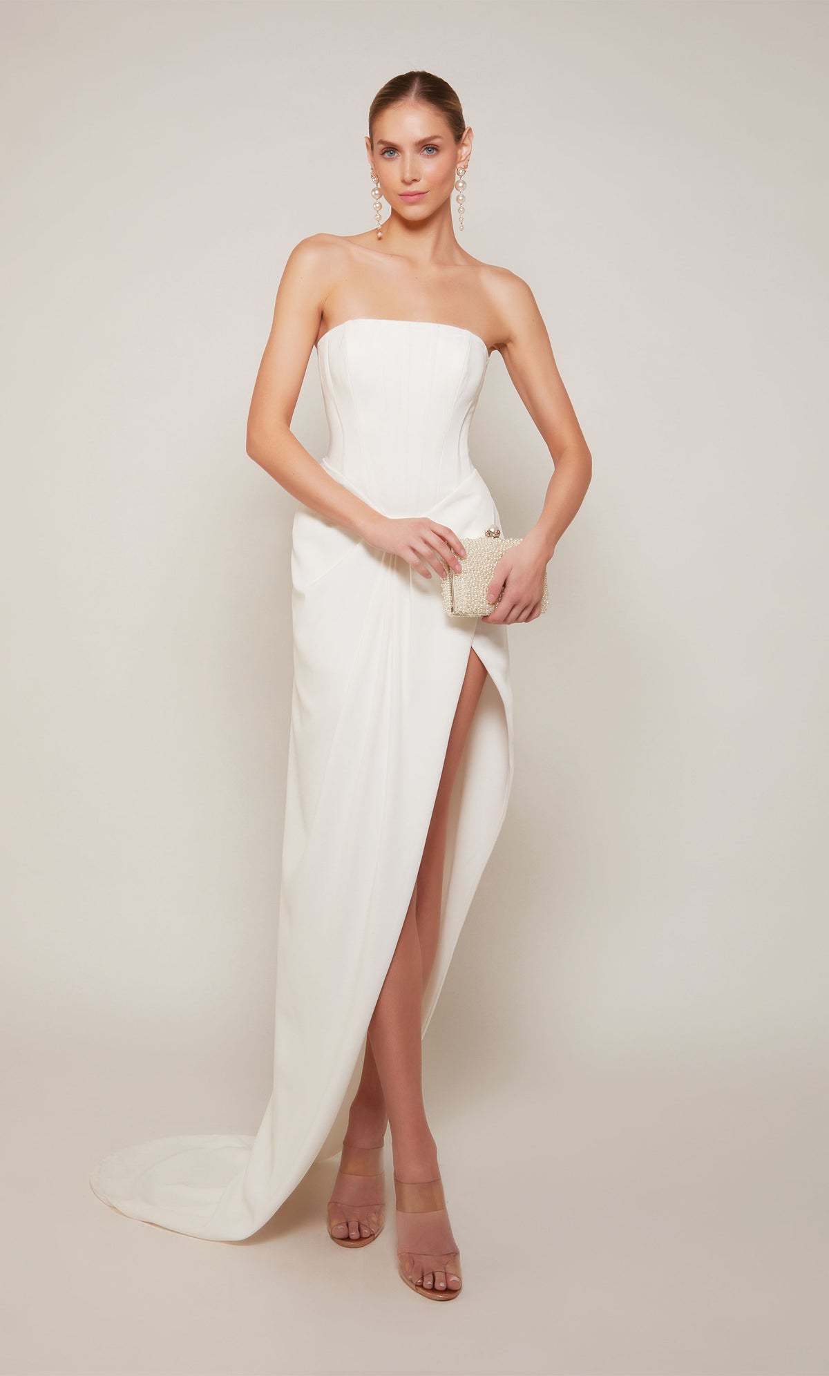 A modern corset gown with an asymmetrical hemline and slight train in ivory.