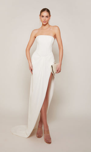 A modern corset wedding dress with a high-low hemline and slight train in ivory.
