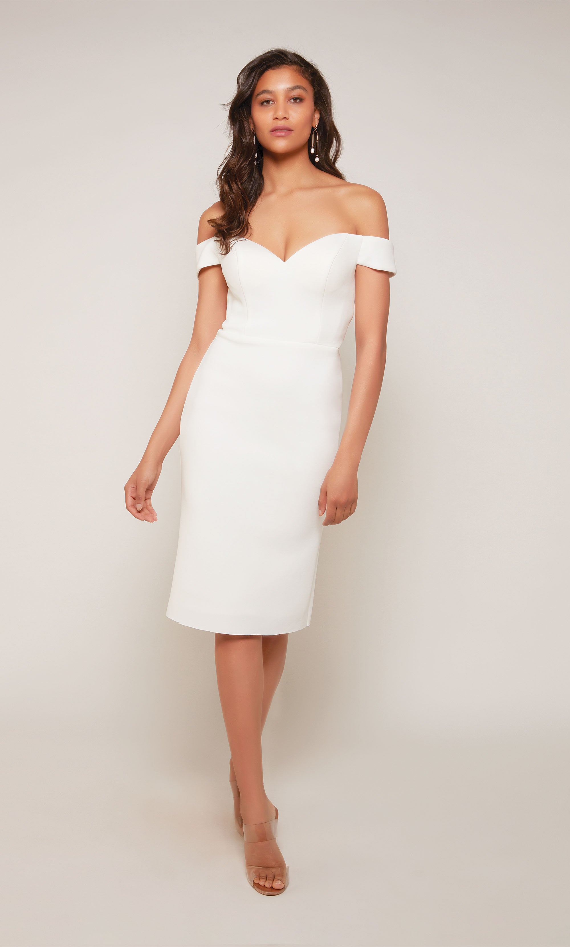 A simple, short wedding dress with an off the shoulder sweetheart neckline and a zipper back closure in diamond white.