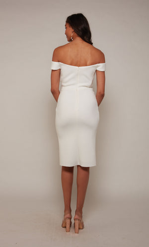 A simple, short wedding dress with an off the shoulder sweetheart neckline and a zipper back closure in diamond white.