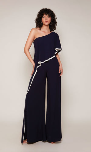 A wide leg, formal jumpsuit with a one shoulder neckline and draped bodice in navy blue with ivory trim.