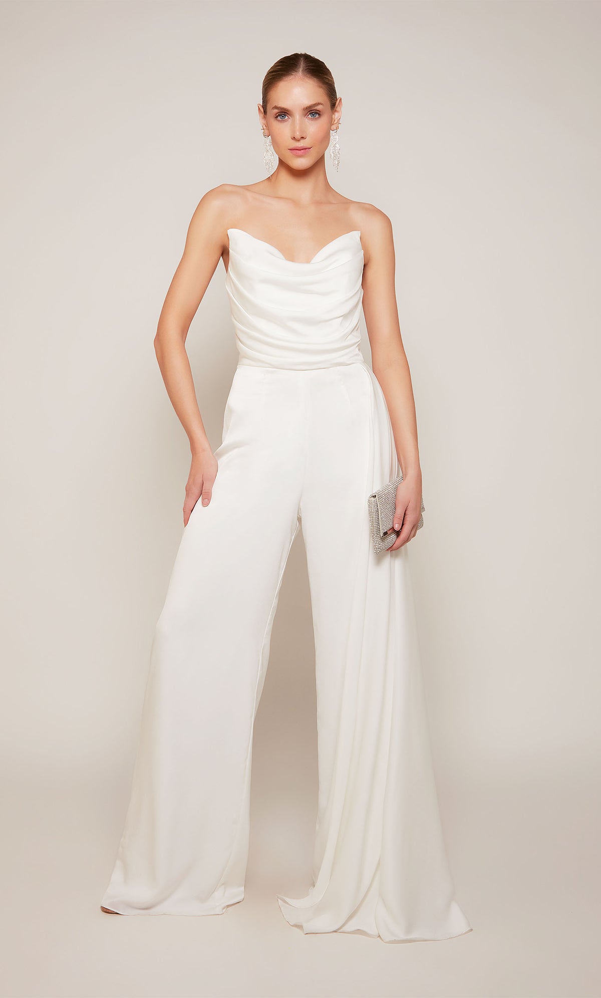 A chic white wedding jumpsuit with a ruched top and cascading drape, and wide leg pant.