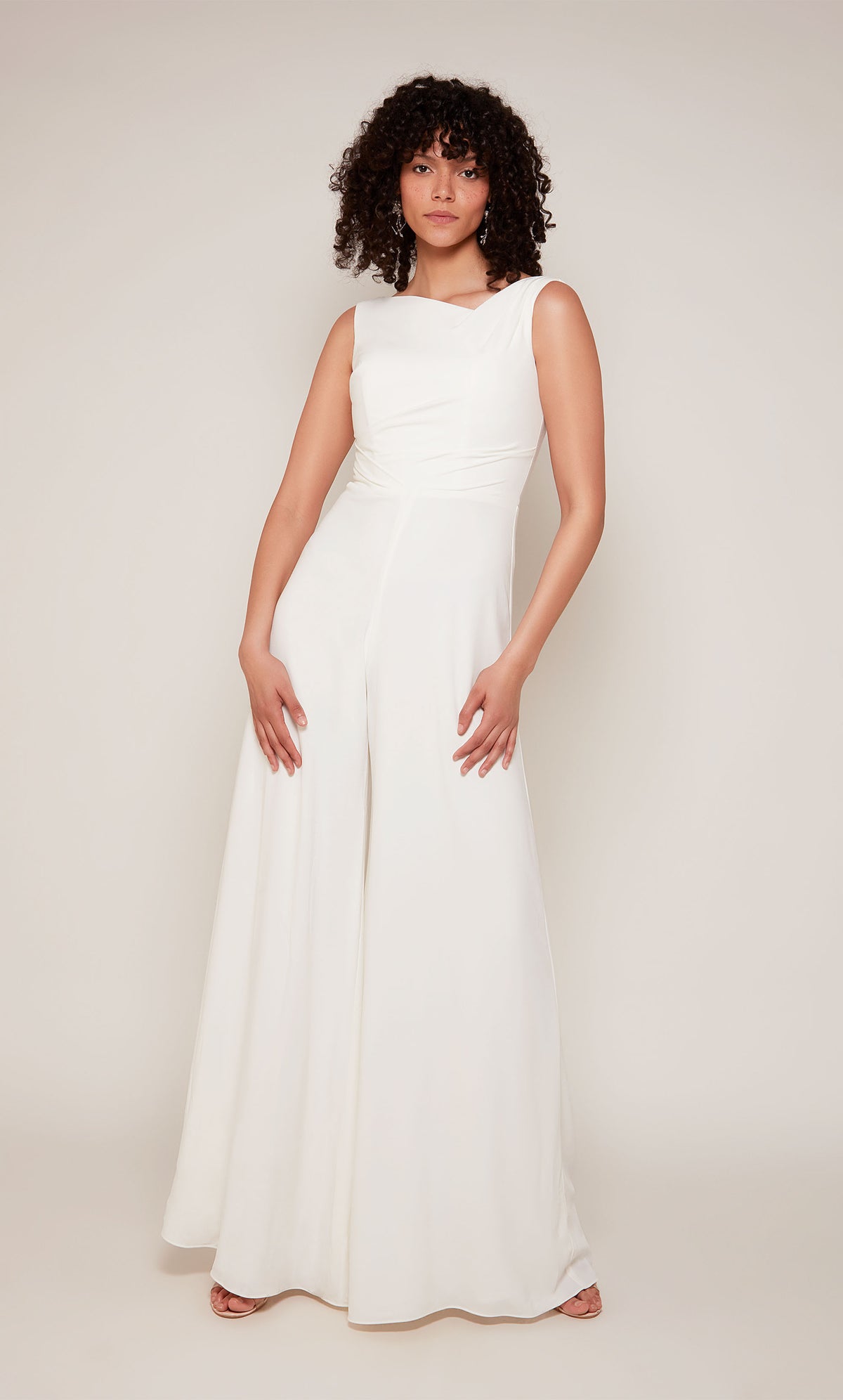 A white formal jumpsuit with an off center V-shaped neckline and wide leg pant.