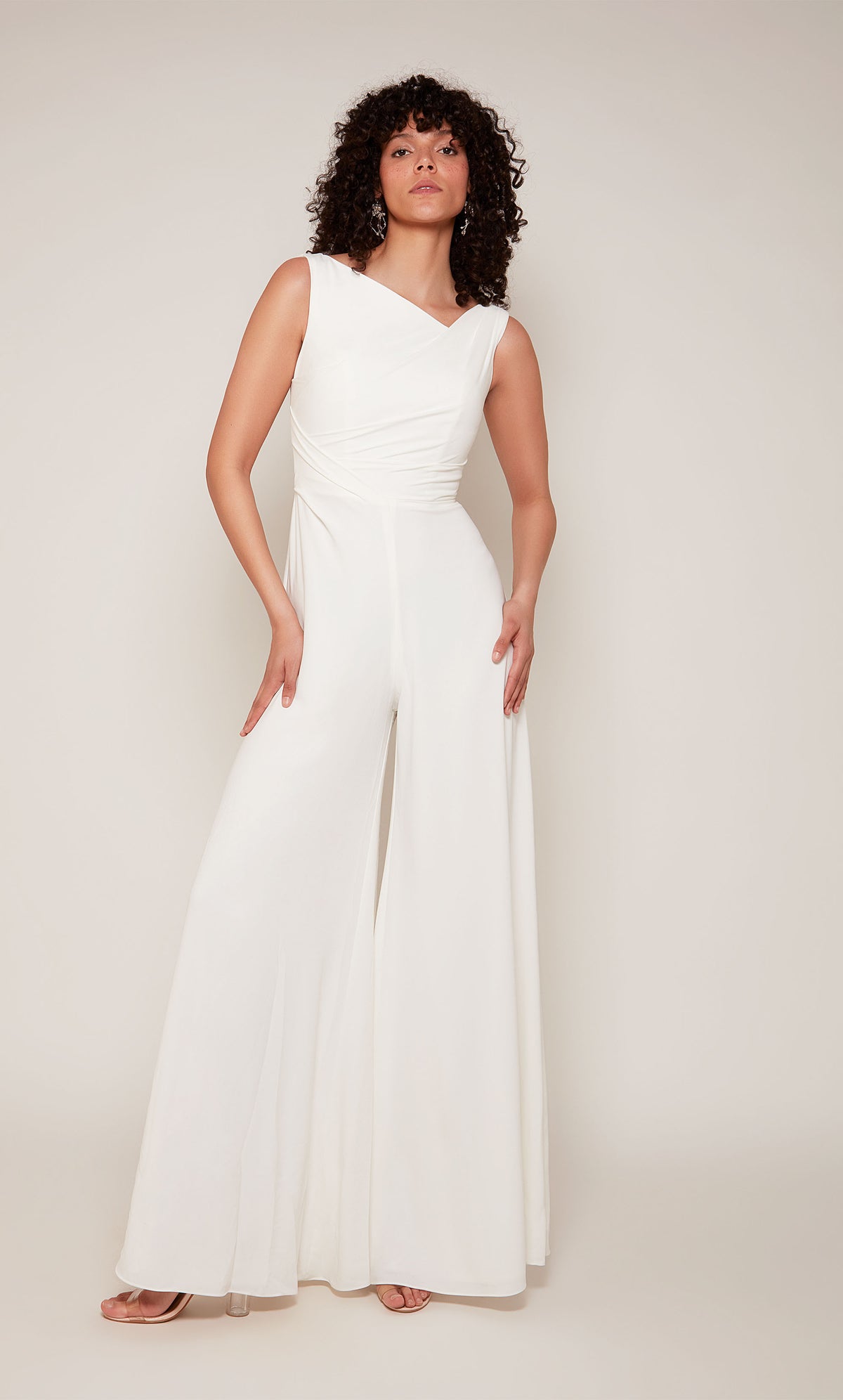 A white formal jumpsuit with an off center V-shaped back and wide leg pant.