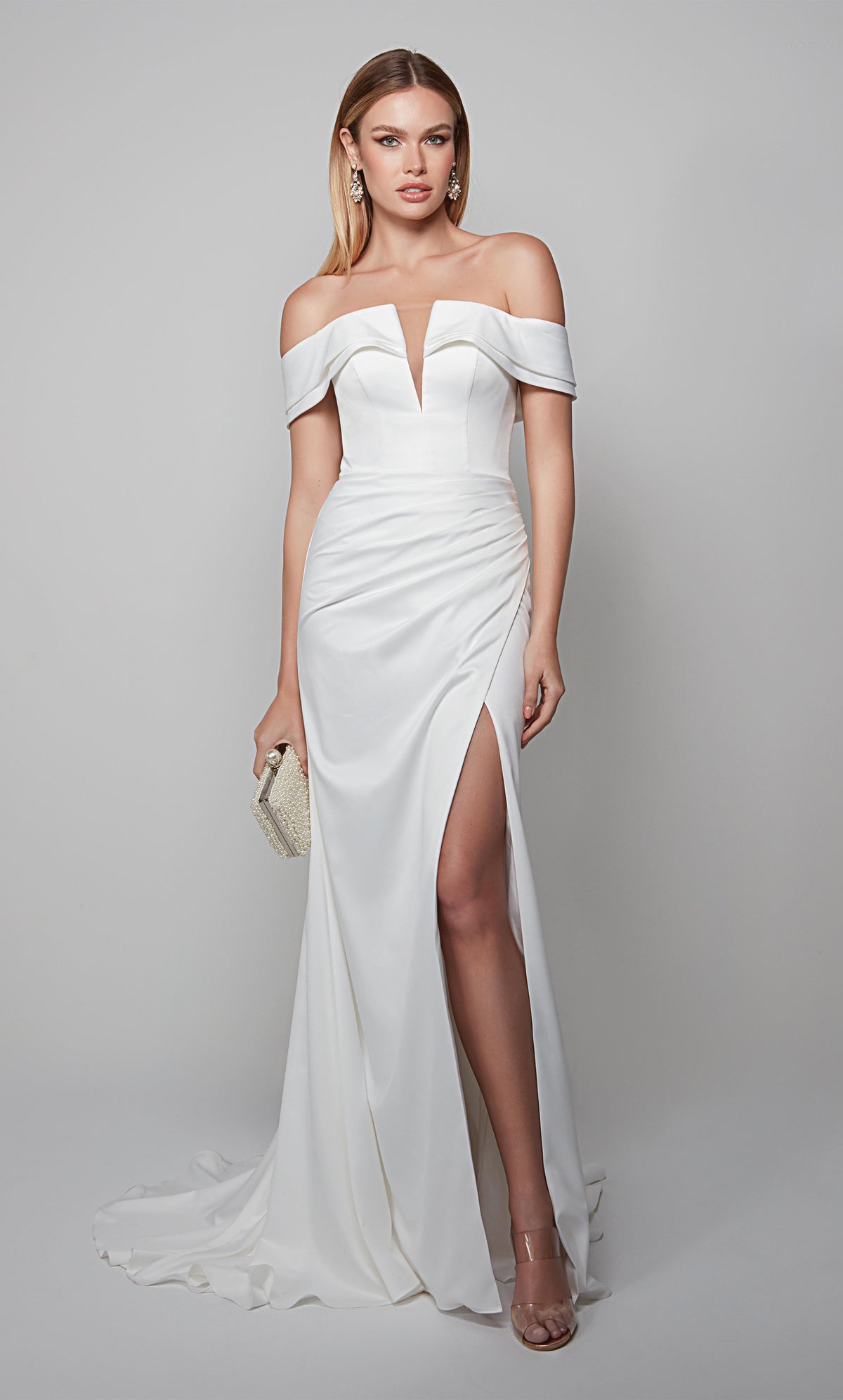 Elegant off the shoulder wedding gown with a plunging neckline, ruching detail, and side slit.