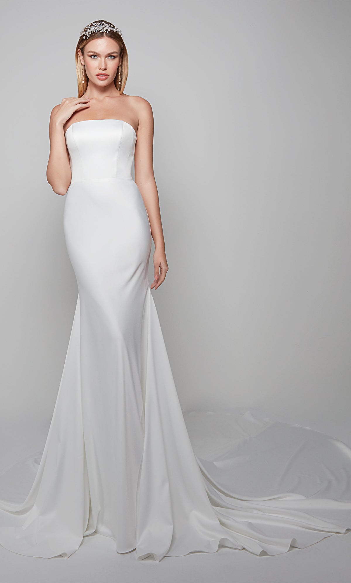 Simple wedding dress with a strapless neckline and fit and flare design in white.