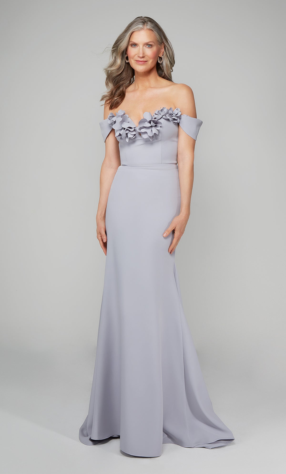 Ice blue fit and flare gala dress featuring an off the shoulder bodice enhanced with a beautiful flower volant.