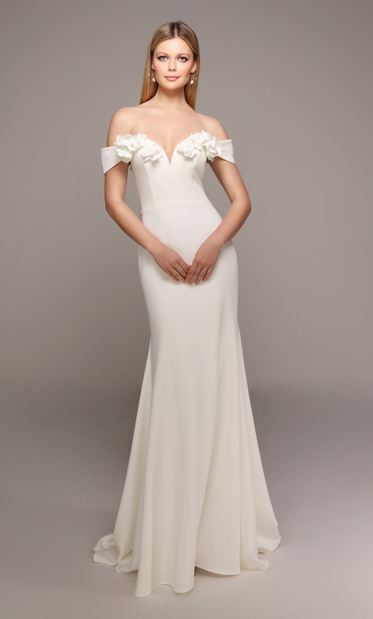 Ivory fit and flare wedding dress featuring an off the shoulder bodice enhanced with a beautiful flower volant and train.