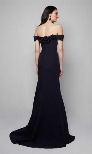 Midnight blue fit and flare mother of the bride dress featuring an off the shoulder bodice enhanced with a beautiful flower volant and train.