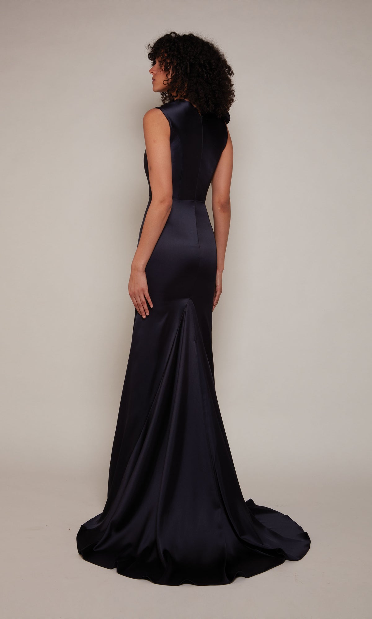 Midnight blue duchess satin gown with an closed zipper back, fit and flare silhouette, and train.