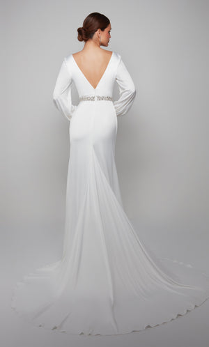Plunging long sleeve wedding gown enhanced with a deep V back, faux belt at the natural waist, and gorgeous train.
