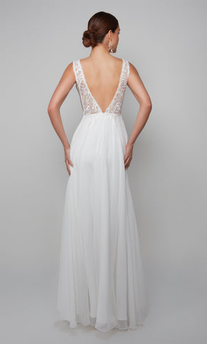 Plunging boho wedding dress with an elegant lace bodice, deep V back style, and flowy chiffon skirt in white.